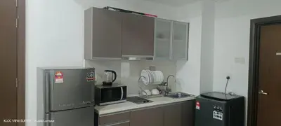 a small kitchen with a refrigerator and a microwave at Serene Haven in Kuala Lumpur