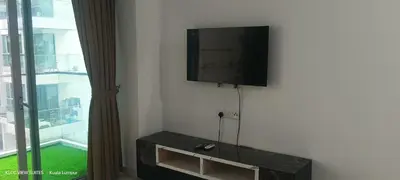 a flat screen tv on a wall next to a window at Serene Haven in Kuala Lumpur