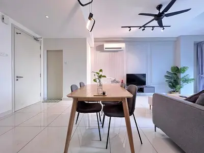 a living room with a table and a ceiling fan at Arte Mont Kiara By Comfortstay in Kuala Lumpur