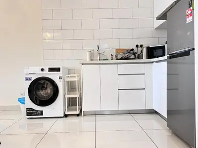 a kitchen with a washing machine and a sink at Arte Mont Kiara By Comfortstay in Kuala Lumpur