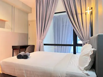 a bedroom with a large bed with a window at Arte Mont Kiara By Comfortstay in Kuala Lumpur