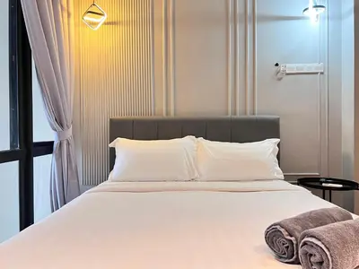 a bedroom with a large bed with white sheets and pillows at Arte Mont Kiara By Comfortstay in Kuala Lumpur