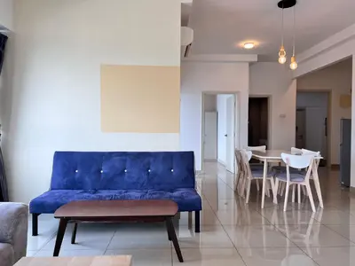 a living room with a blue couch and a table at Arte Plus Ampang By Comfortstay in Kuala Lumpur