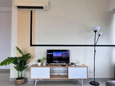 a living room with a desk with a computer on it at Arte Plus Ampang By Comfortstay in Kuala Lumpur