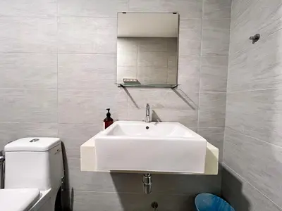 a bathroom with a white sink and a mirror at Arte Plus Ampang By Comfortstay in Kuala Lumpur