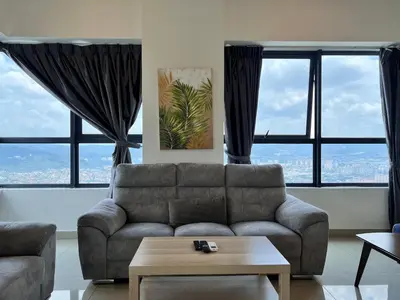 a living room with a couch and large windows at Arte Plus Ampang By Comfortstay in Kuala Lumpur