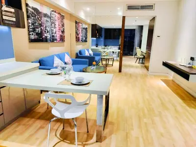 a living room with a white table and a blue couch at Oneiro D'Majestic place Klcc in Kuala Lumpur