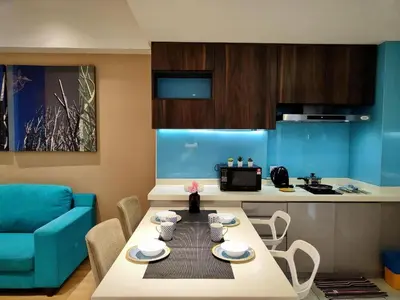 a living room with a table and a kitchen at Oneiro D'Majestic place Klcc in Kuala Lumpur