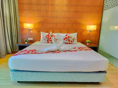 a bedroom with a large bed with red flowers on it at Oneiro D'Majestic place Klcc in Kuala Lumpur