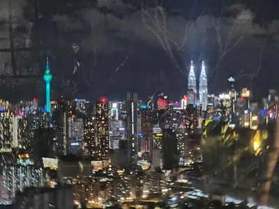 a view of a city skyline at night at TRION KL Family Residence at Kuala Lumpur in Kuala Lumpur