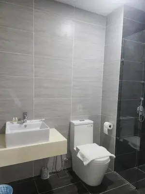 a bathroom with a toilet and a sink at TRION KL Family Residence at Kuala Lumpur in Kuala Lumpur