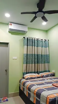 a bedroom with a bed with a ceiling fan at Twin Tower View Homestay Kuala Lumpur in Kuala Lumpur