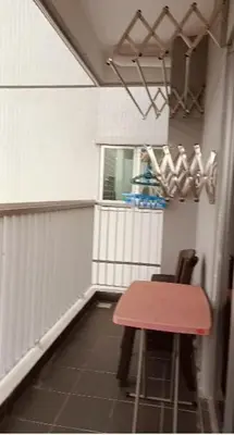 a room with a table and a red table and chair at Twin Tower View Homestay Kuala Lumpur in Kuala Lumpur