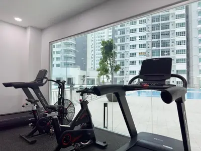 two exercise bikes in a room with a large window at Twin Tower View Homestay Kuala Lumpur in Kuala Lumpur