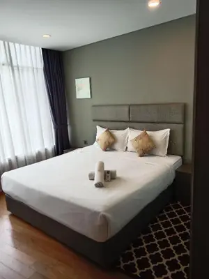a bedroom with a bed with two teddy bears on it at Vortex Suites KLCC By Farysha in Kuala Lumpur