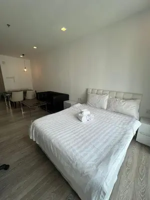 a bedroom with a large white bed with two towels on it at Nice & convenient Studio in KL in Kuala Lumpur