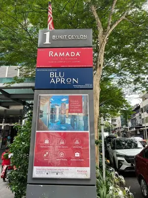 a sign for a bus stop in a city at Nice & convenient Studio in KL in Kuala Lumpur