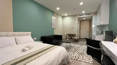 a hotel room with a bed and a dining room at Stylish Studio in ChangKat in Kuala Lumpur