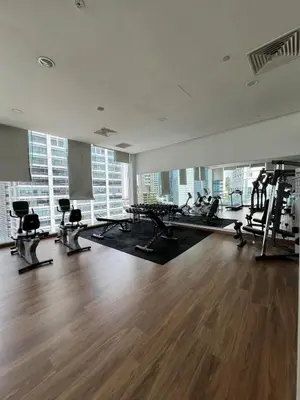 a gym with treadmills and exercise equipment in a building at Stylish Studio in ChangKat in Kuala Lumpur