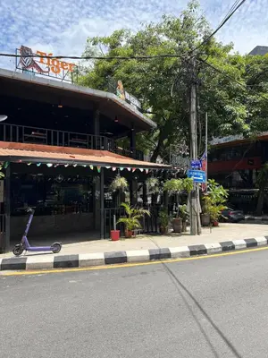 a scooter parked in front of a building on a street at Stylish Studio in ChangKat in Kuala Lumpur