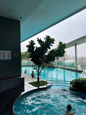 a swimming pool with a tree in a building at Casa Residency in BBCC in Kuala Lumpur