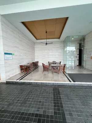 a dining area with tables and chairs in a building at Casa Residency in BBCC in Kuala Lumpur