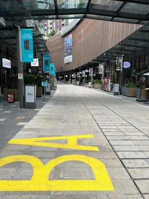 an empty shopping mall with a yellow sign on the ground at Casa Residency in Bukit in Kuala Lumpur