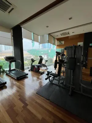 a gym with several exercise equipment in a room at Near Jalan Alor in Kuala Lumpur