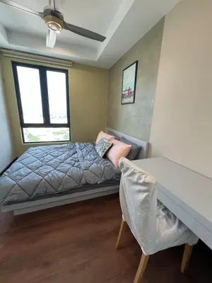a bedroom with a bed and a desk and a window at Comfy place near Bukit in Kuala Lumpur