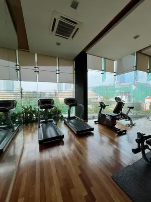 a gym with several cardio machines in a room with windows at Spacious and Inviting casa Residence in Kuala Lumpur