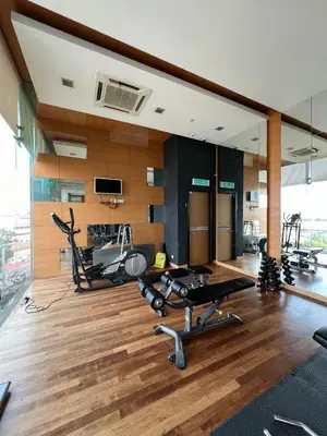 a gym with treadmills and elliptical machines at Spacious and Inviting casa Residence in Kuala Lumpur