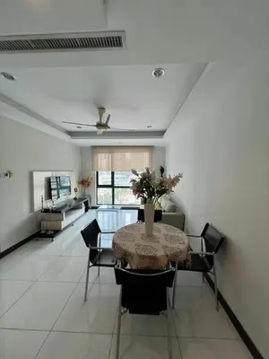 a dining room with a table with a vase of flowers on it at Spacious and Inviting casa Residence in Kuala Lumpur