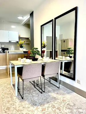 a dining room with a table and chairs and a kitchen at Ayuanura Homestay in Kuala Lumpur