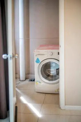 a washer and dryer in a small room at Dorsett Residences Sri Hartamas, Mont Kiara Kuala Lumpur in Kuala Lumpur