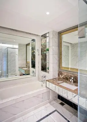 a bathroom with a tub and a sink and a mirror at Dorsett Residences Sri Hartamas, Mont Kiara Kuala Lumpur in Kuala Lumpur