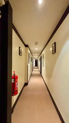 a long hallway with a fire hydrant in a building at Star Mews Hotel Changkat Bukit Bintang in Kuala Lumpur