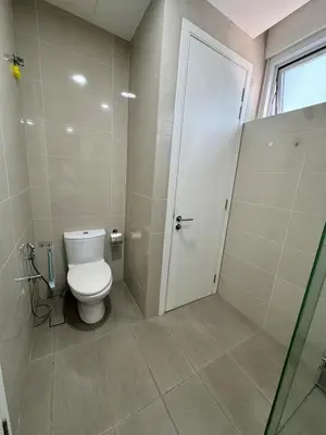a bathroom with a toilet and a door at Convenient KLCC in Kuala Lumpur