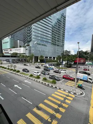 a view of a parking lot with cars in a city at Convenient KLCC in Kuala Lumpur