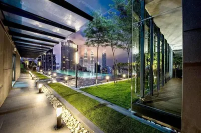 a building with a view of a city at night at Dorsett Residence TRX KLCC #25 in Kuala Lumpur