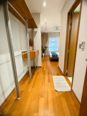 a room with a hallway with a bed and a hard wood floor at Sky Suites KLCC Apartment by Family Room Stay in Kuala Lumpur