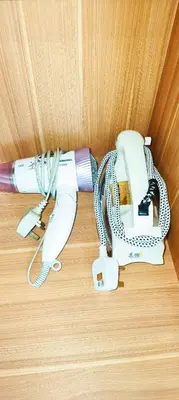 a camera with a cord attached to a wall at Sky Suites KLCC Apartment by Family Room Stay in Kuala Lumpur