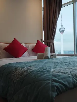 a bedroom with a bed with a view of the television tower at Sky Suites KLCC Apartment by Family Room Stay in Kuala Lumpur