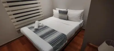 a small white bed in a small room at Sky Suites KLCC Apartment by Family Room Stay in Kuala Lumpur