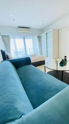 a living room with a blue bed and a table at Summer Suites by Western Holiday in Kuala Lumpur