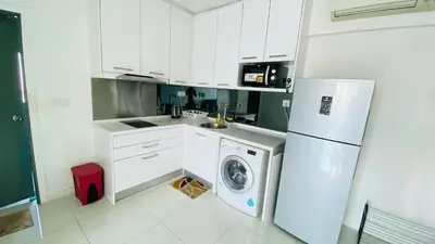 a kitchen with a white refrigerator and a washing machine at Summer Suites by Western Holiday in Kuala Lumpur
