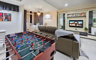a living room with a pool table and a tv at Bukit Bintang Fahrenheit #113 KLCC Kuala Lumpur in Kuala Lumpur