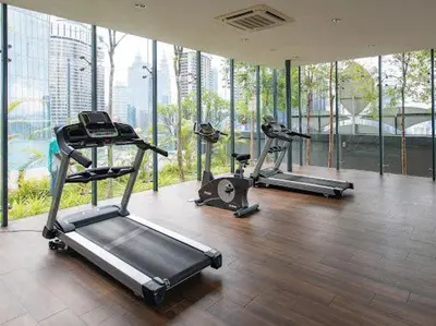 a gym with three tread machines in a room with windows at Dorsett Residence #13 Kuala Lumpur Bukit Bintang TRX in Kuala Lumpur