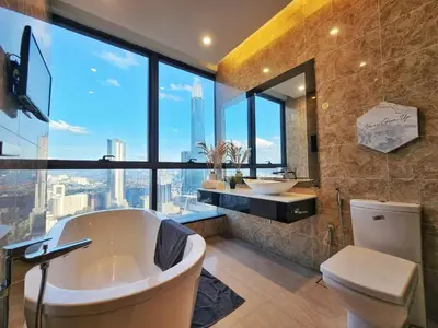 a bathroom with a tub and a toilet and a window at Dorsett Residence #13 Kuala Lumpur Bukit Bintang TRX in Kuala Lumpur