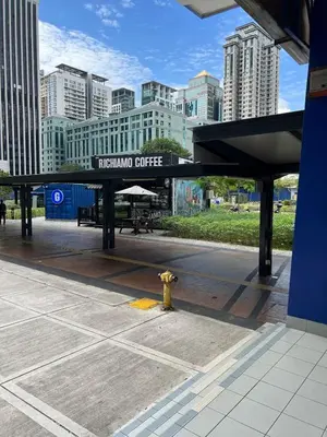 a train station with a fire hydrant in a city at Cosy 2-bedroom KLCC in Kuala Lumpur