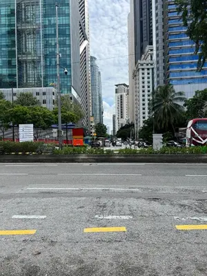 an empty street in a city with tall buildings at Great Value 2-Bedroom KLCC Unit in Kuala Lumpur